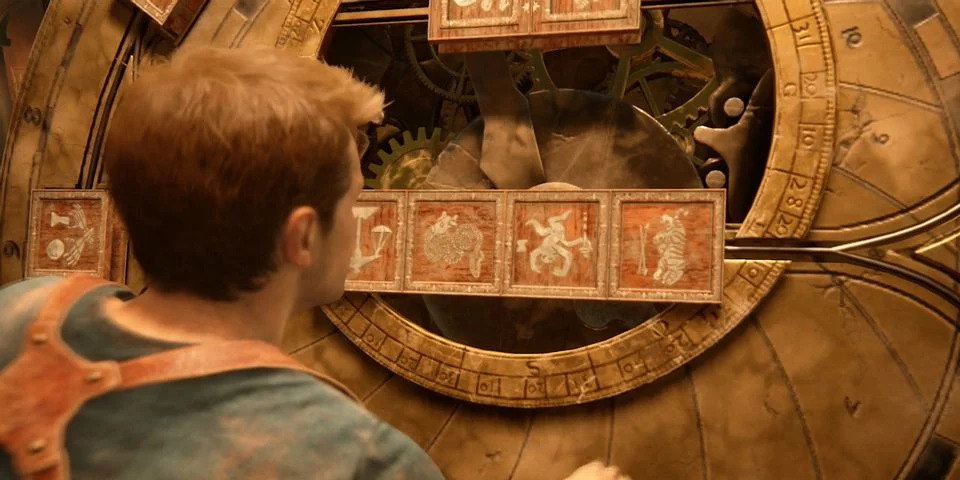 Nathan Drake from the Uncharted series stares at a beige wall full of puzzle glyphs
